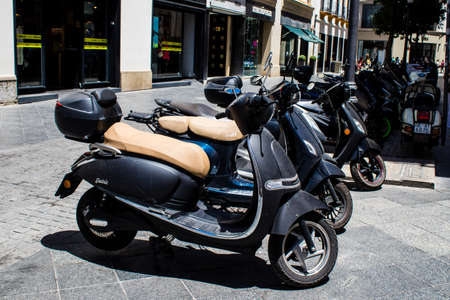 Seville, Spain - July 04, 2022 Scooters parked in the streets of Seville, an emblematic city and the capital of the region of Andalusiaのeditorial素材