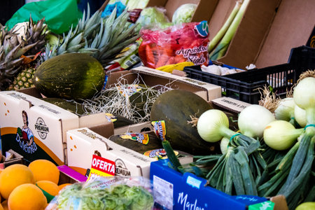 Seville, Spain - July 04, 2022 Vegetables and fruits sold at the Triana market in Seville during the coronavirus outbreak hitting Spain, wearing a mask is mandatoryのeditorial素材
