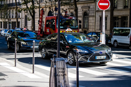 Paris, France - September 14, 2022 Taxi driving through the streets of Paris, This mode of transport...
