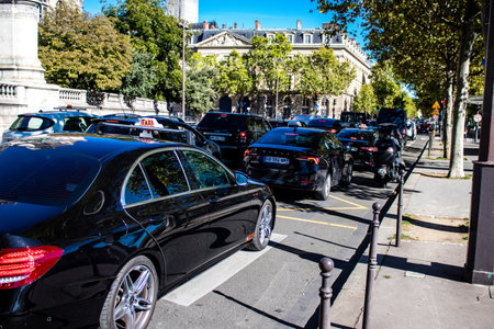 Paris, France - September 14, 2022 Taxi driving through the streets of Paris, This mode of transport is famous and widely used by Parisians and tourists, several companies compete in the city of Parisのeditorial素材