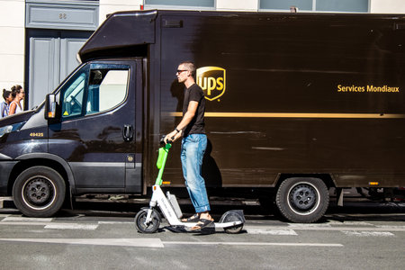 Paris, France - September 14, 2022 People rolling with an electric scooter in the streets of Paris,...