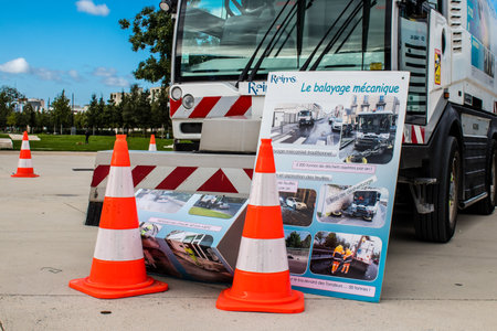 Reims, France - September 17, 2022 Street cleaning cars and garbage truck parked in the streets of...