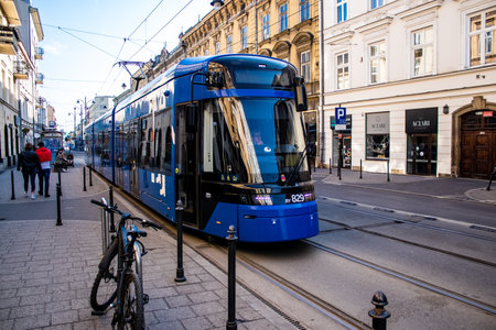 Krakow, Poland - October 08, 2022 Modern electric tram driving in the streets of Krakow and part of the transport system of the city, the fares are not expensiveのeditorial素材