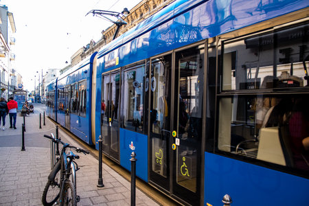 Krakow, Poland - October 08, 2022 Modern electric tram driving in the streets of Krakow and part of the transport system of the city, the fares are not expensiveのeditorial素材
