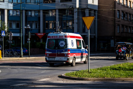 Krakow, Poland - October 08, 2022 Ambulance driving in the city center of Krakow in Poland during the coronavirus outbreak, wearing a mask is not compulsory on the streetのeditorial素材