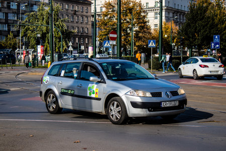 Krakow, Poland - October 08, 2022 Taxi driving in the streets of Krakow and part of the transport system of the city, several taxi companies compete for this activity and the fares are not expensiveのeditorial素材