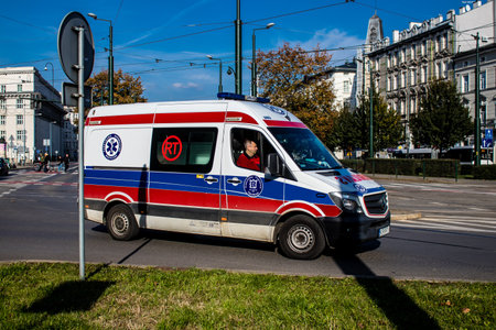 Krakow, Poland - October 08, 2022 Ambulance driving in the city center of Krakow in Poland during the coronavirus outbreak, wearing a mask is not compulsory on the streetのeditorial素材