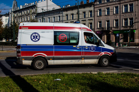 Krakow, Poland - October 08, 2022 Ambulance driving in the city center of Krakow in Poland during the coronavirus outbreak, wearing a mask is not compulsory on the streetのeditorial素材
