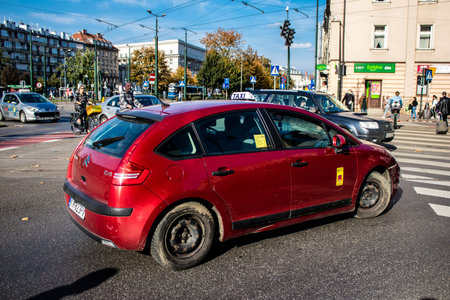 Krakow, Poland - October 08, 2022 Taxi driving in the streets of Krakow and part of the transport system of the city, several taxi companies compete for this activity and the fares are not expensiveのeditorial素材