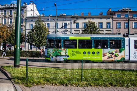 Krakow, Poland - October 08, 2022 Modern electric tram driving in the streets of Krakow and part of the transport system of the city, the fares are not expensiveのeditorial素材