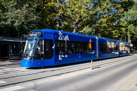 Krakow, Poland - October 08, 2022 Modern electric tram driving in the streets of Krakow and part of the transport system of the city, the fares are not expensiveのeditorial素材