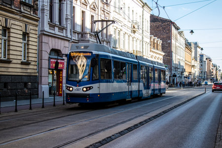 Krakow, Poland - October 08, 2022 Modern electric tram driving in the streets of Krakow and part of the transport system of the city, the fares are not expensiveのeditorial素材