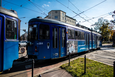Krakow, Poland - October 08, 2022 Modern electric tram driving in the streets of Krakow and part of the transport system of the city, the fares are not expensiveのeditorial素材
