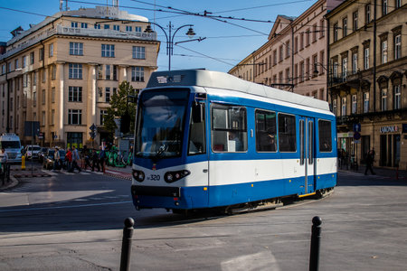 Krakow, Poland - October 08, 2022 Modern electric tram driving in the streets of Krakow and part of the transport system of the city, the fares are not expensiveのeditorial素材