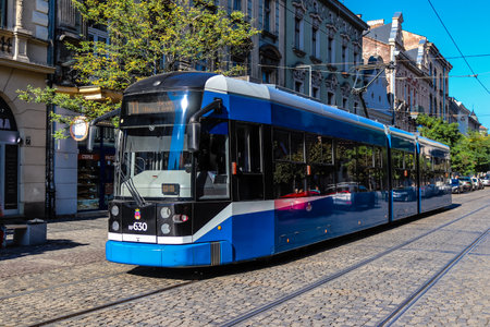 Krakow, Poland - October 08, 2022 Modern electric tram driving in the streets of Krakow and part of the transport system of the city, the fares are not expensiveのeditorial素材