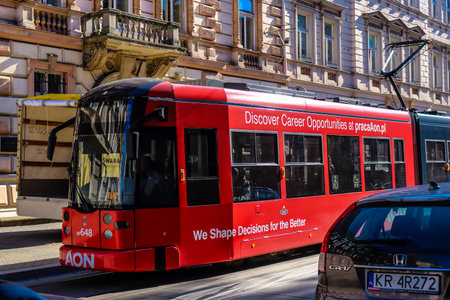 Krakow, Poland - October 08, 2022 Modern electric tram driving in the streets of Krakow and part of the transport system of the city, the fares are not expensiveのeditorial素材