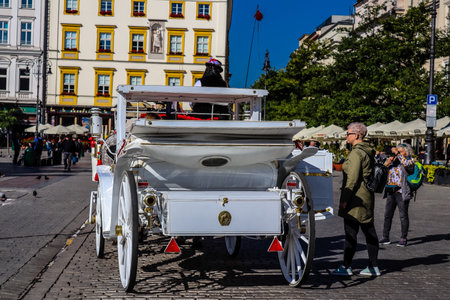 Krakow, Poland - October 08, 2022 Horse drawn carriage rides have become one of the main attractions in Krakow. Their very beautiful horse drawn carriages will take you around the city centerのeditorial素材