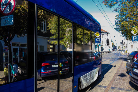 Krakow, Poland - October 08, 2022 Modern electric tram driving in the streets of Krakow and part of the transport system of the city, the fares are not expensiveのeditorial素材