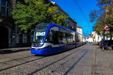 Krakow, Poland - October 08, 2022 Modern electric tram driving in the streets of Krakow and part of the transport system of the city, the fares are not expensiveのeditorial素材