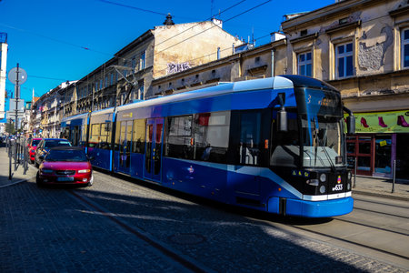 Krakow, Poland - October 08, 2022 Modern electric tram driving in the streets of Krakow and part of the transport system of the city, the fares are not expensiveのeditorial素材