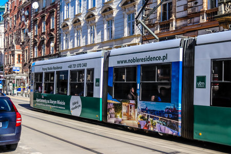 Krakow, Poland - October 08, 2022 Modern electric tram driving in the streets of Krakow and part of the transport system of the city, the fares are not expensiveのeditorial素材