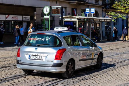 Krakow, Poland - October 08, 2022 Taxi driving in the streets of Krakow and part of the transport system of the city, several taxi companies compete for this activity and the fares are not expensiveのeditorial素材