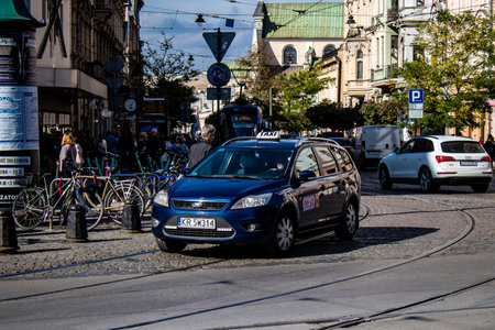Krakow, Poland - October 08, 2022 Taxi driving in the streets of Krakow and part of the transport system of the city, several taxi companies compete for this activity and the fares are not expensiveのeditorial素材