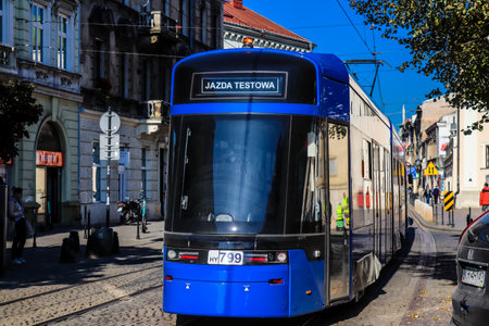 Krakow, Poland - October 08, 2022 Modern electric tram driving in the streets of Krakow and part of the transport system of the city, the fares are not expensiveのeditorial素材