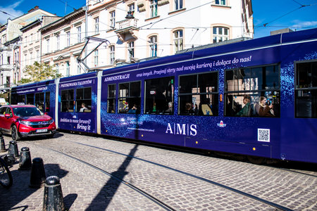 Krakow, Poland - October 08, 2022 Modern electric tram driving in the streets of Krakow and part of the transport system of the city, the fares are not expensiveのeditorial素材