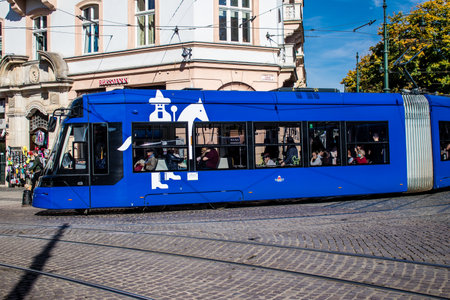 Krakow, Poland - October 08, 2022 Modern electric tram driving in the streets of Krakow and part of the transport system of the city, the fares are not expensiveのeditorial素材