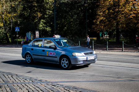 Krakow, Poland - October 08, 2022 Taxi driving in the streets of Krakow and part of the transport system of the city, several taxi companies compete for this activity and the fares are not expensiveのeditorial素材