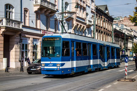 Krakow, Poland - October 08, 2022 Modern electric tram driving in the streets of Krakow and part of the transport system of the city, the fares are not expensiveのeditorial素材