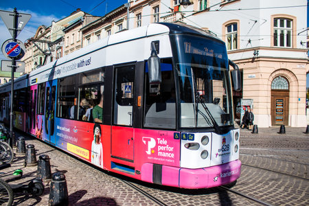 Krakow, Poland - October 08, 2022 Modern electric tram driving in the streets of Krakow and part of the transport system of the city, the fares are not expensiveのeditorial素材