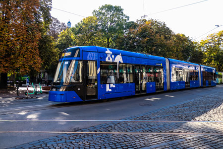 Krakow, Poland - October 08, 2022 Modern electric tram driving in the streets of Krakow and part of the transport system of the city, the fares are not expensiveのeditorial素材