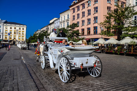 Krakow, Poland - October 08, 2022 Horse drawn carriage rides have become one of the main attractions in Krakow. Their very beautiful horse drawn carriages will take you around the city centerのeditorial素材