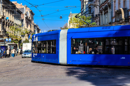 Krakow, Poland - October 08, 2022 Modern electric tram driving in the streets of Krakow and part of the transport system of the city, the fares are not expensiveのeditorial素材