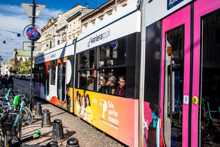 Krakow, Poland - October 08, 2022 Modern electric tram driving in the streets of Krakow and part of the transport system of the city, the fares are not expensiveのeditorial素材