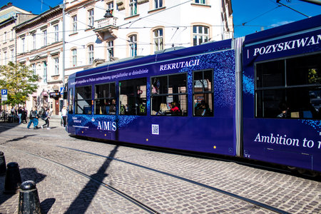 Krakow, Poland - October 08, 2022 Modern electric tram driving in the streets of Krakow and part of the transport system of the city, the fares are not expensiveのeditorial素材