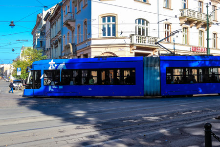 Krakow, Poland - October 08, 2022 Modern electric tram driving in the streets of Krakow and part of the transport system of the city, the fares are not expensiveのeditorial素材