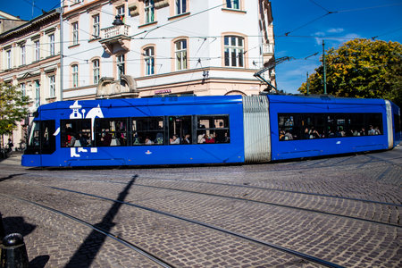 Krakow, Poland - October 08, 2022 Modern electric tram driving in the streets of Krakow and part of the transport system of the city, the fares are not expensiveのeditorial素材