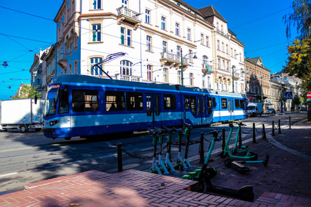 Krakow, Poland - October 08, 2022 Modern electric tram driving in the streets of Krakow and part of the transport system of the city, the fares are not expensiveのeditorial素材