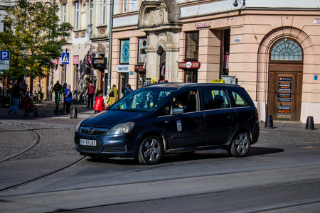 Krakow, Poland - October 08, 2022 Taxi driving in the streets of Krakow and part of the transport system of the city, several taxi companies compete for this activity and the fares are not expensiveのeditorial素材