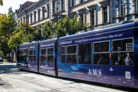 Krakow, Poland - October 08, 2022 Modern electric tram driving in the streets of Krakow and part of the transport system of the city, the fares are not expensiveのeditorial素材