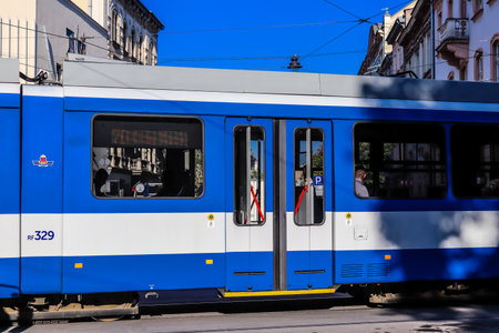 Krakow, Poland - October 08, 2022 Modern electric tram driving in the streets of Krakow and part of the transport system of the city, the fares are not expensiveのeditorial素材