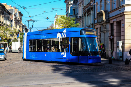 Krakow, Poland - October 08, 2022 Modern electric tram driving in the streets of Krakow and part of the transport system of the city, the fares are not expensiveのeditorial素材