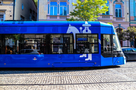 Krakow, Poland - October 08, 2022 Modern electric tram driving in the streets of Krakow and part of the transport system of the city, the fares are not expensiveのeditorial素材