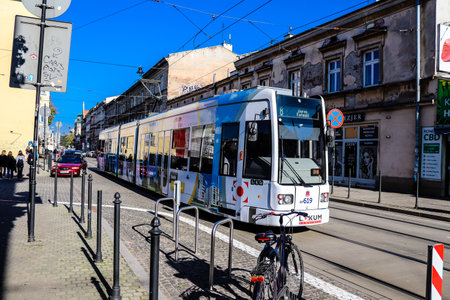 Krakow, Poland - October 08, 2022 Modern electric tram driving in the streets of Krakow and part of the transport system of the city, the fares are not expensiveのeditorial素材