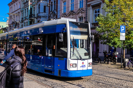Krakow, Poland - October 08, 2022 Modern electric tram driving in the streets of Krakow and part of the transport system of the city, the fares are not expensiveのeditorial素材