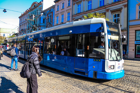 Krakow, Poland - October 08, 2022 Modern electric tram driving in the streets of Krakow and part of the transport system of the city, the fares are not expensiveのeditorial素材