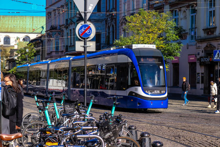 Krakow, Poland - October 08, 2022 Modern electric tram driving in the streets of Krakow and part of the transport system of the city, the fares are not expensiveのeditorial素材